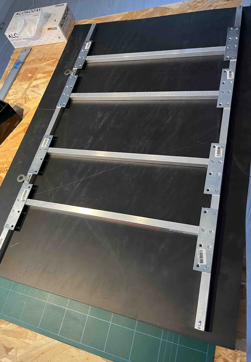 The black back panel with the aluminum structure fixed across it.
